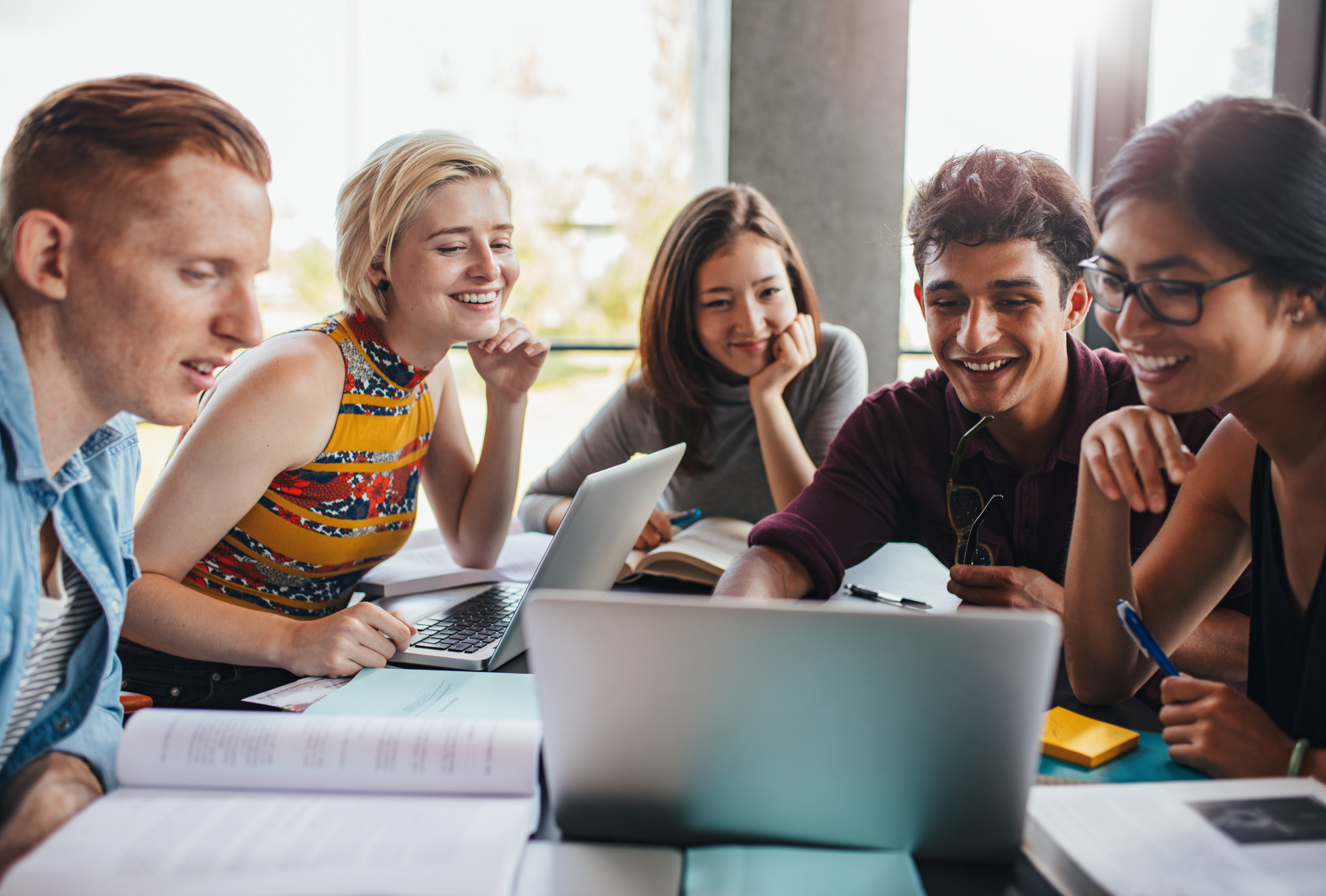 A group of students discussing work