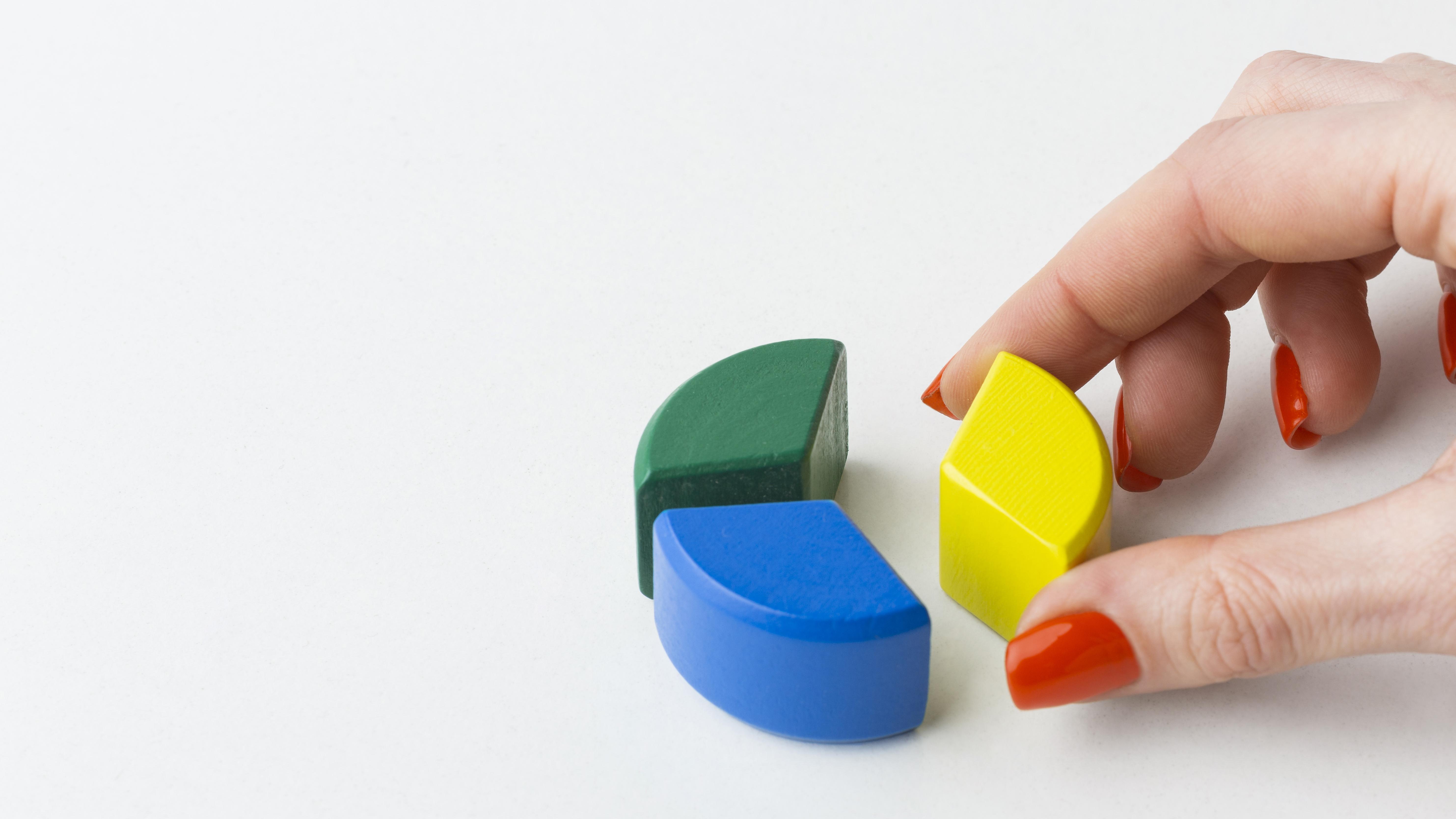 A person putting together blocks together to form a circle