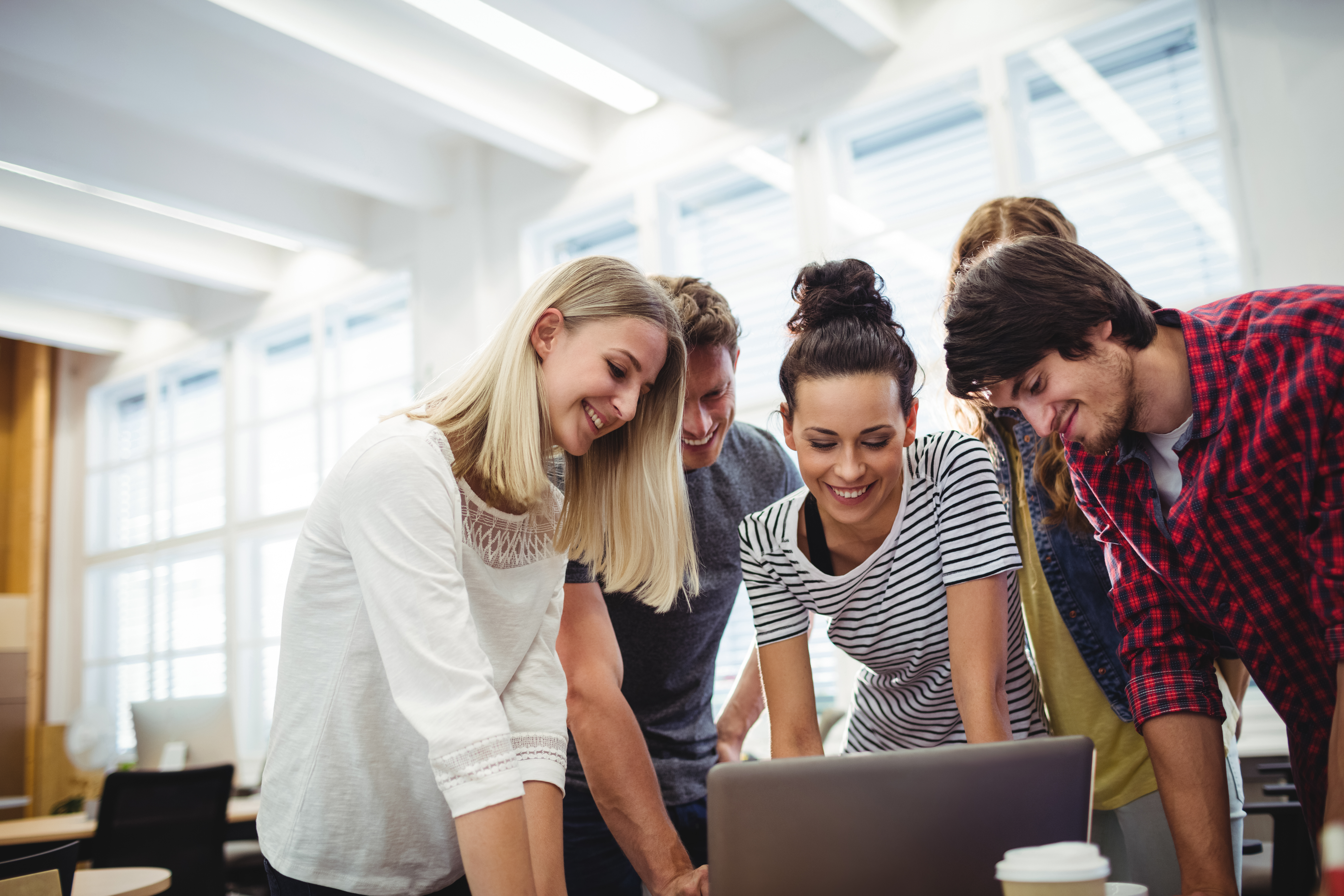 A group of students looking at laptop