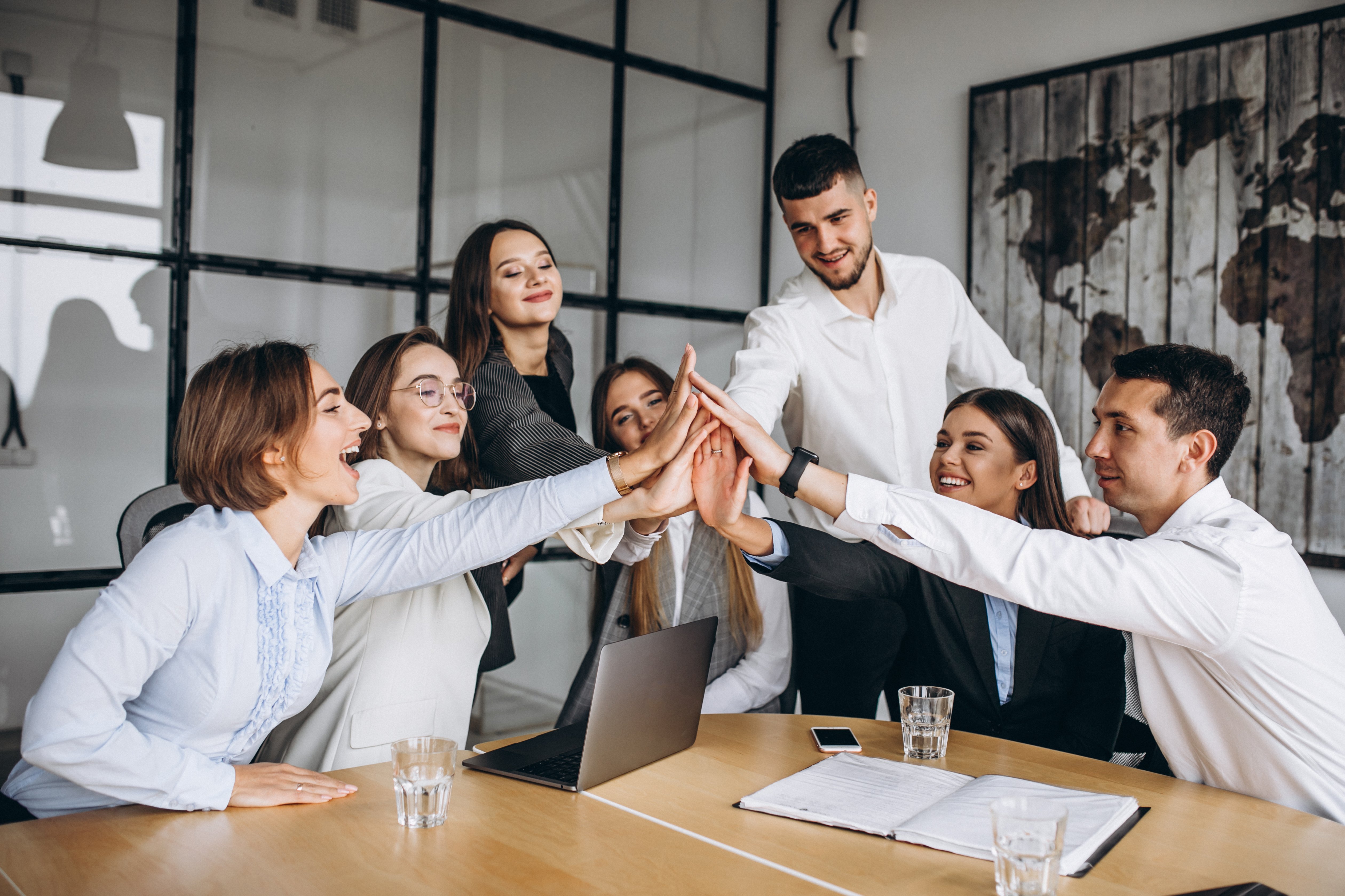 Team of students giving each other a high-five